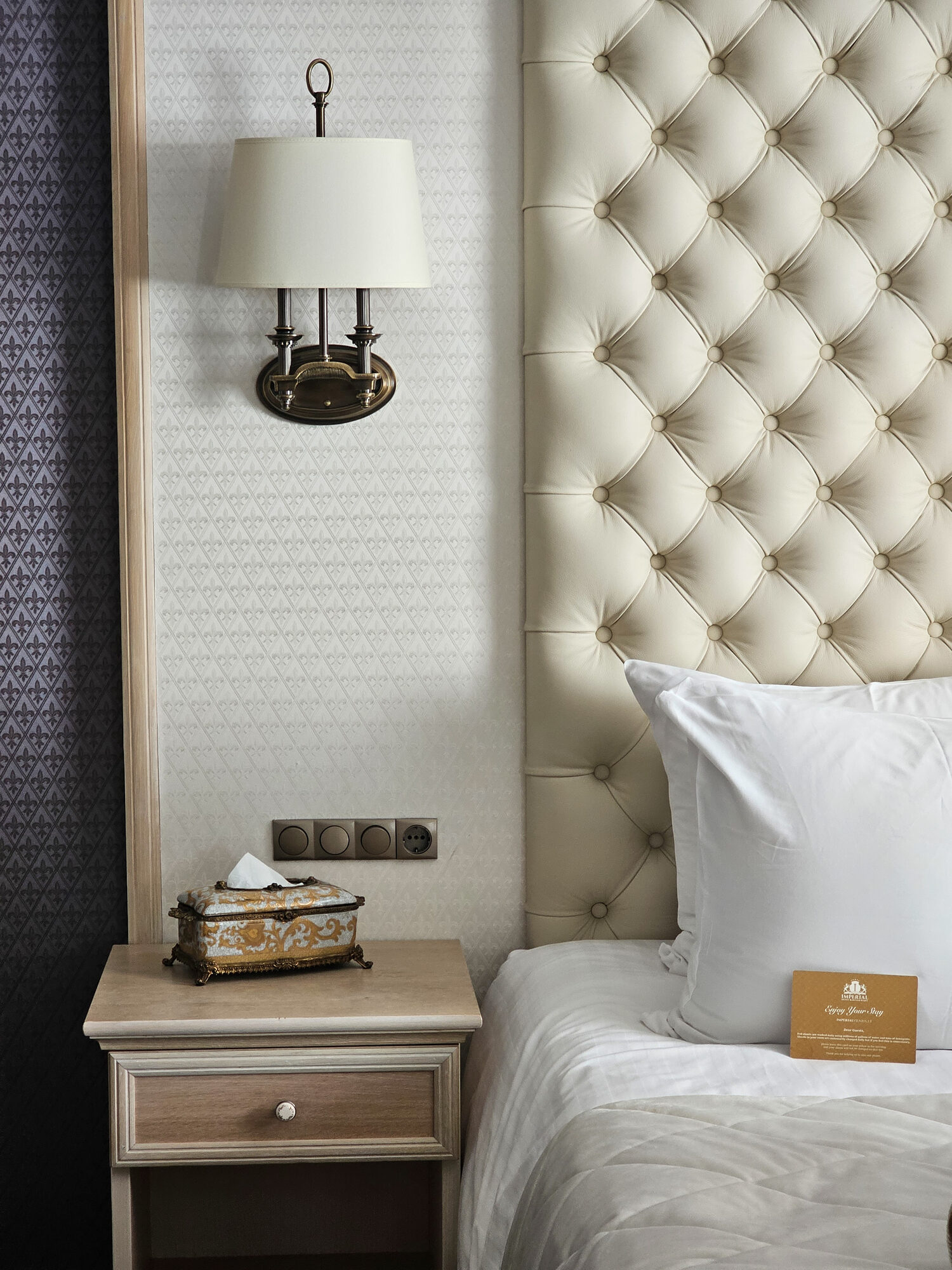 Luxury hotel bed and tufted headboard detail