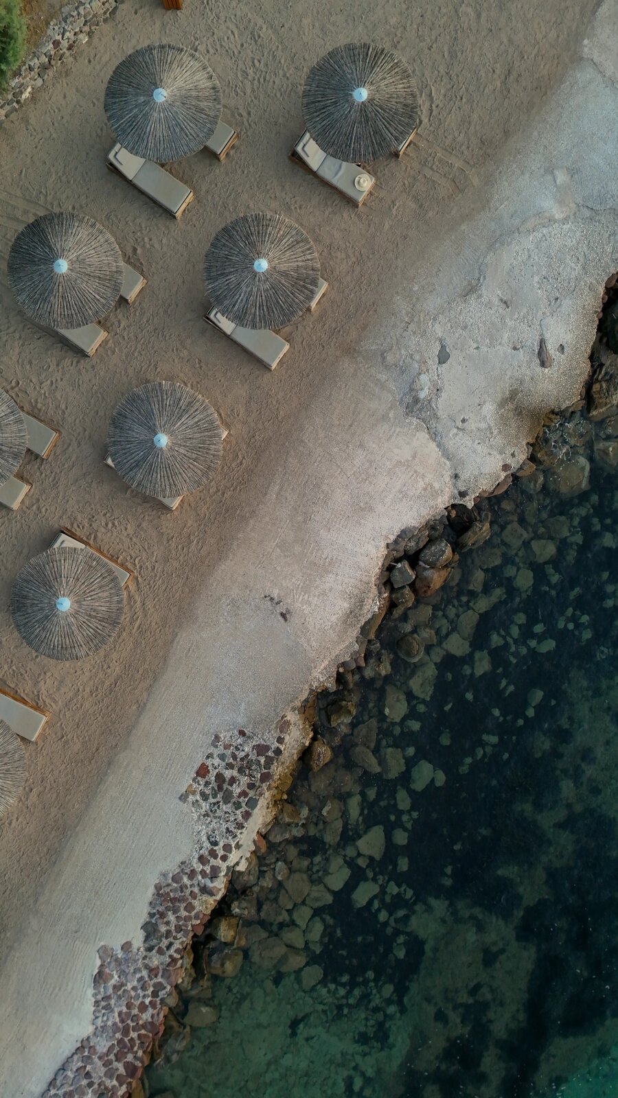 Aerial view of beach umbrellas along the shoreline